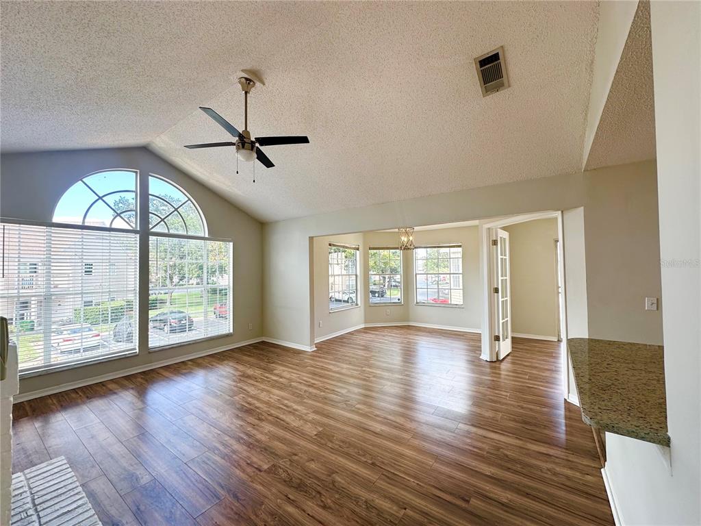 654 Roaring Drive, Unit 228 Altamonte Springs, FL 32714 - Photo 2 of 37 a view of an empty room with wooden floor and a window