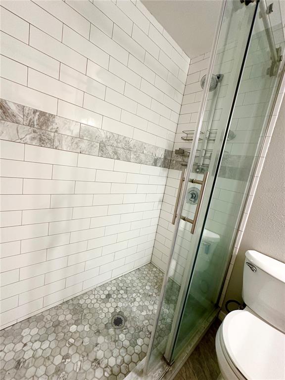 654 Roaring Drive, Unit 228 Altamonte Springs, FL 32714 - Photo 23 of 37 a bathroom with a toilet and shower