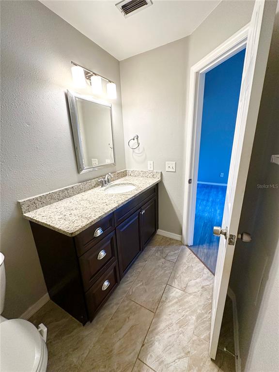654 Roaring Drive, Unit 228 Altamonte Springs, FL 32714 - Photo 24 of 37 a bathroom with a sink vanity and mirror