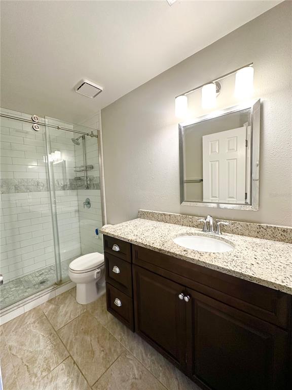 654 Roaring Drive, Unit 228 Altamonte Springs, FL 32714 - Photo 25 of 37 a bathroom with a granite countertop sink toilet and shower