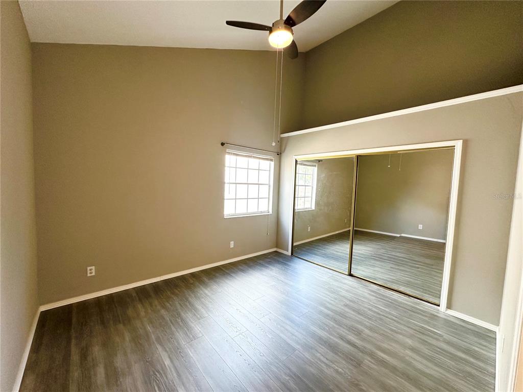 654 Roaring Drive, Unit 228 Altamonte Springs, FL 32714 - Photo 28 of 37 an empty room with wooden floor closet and windows