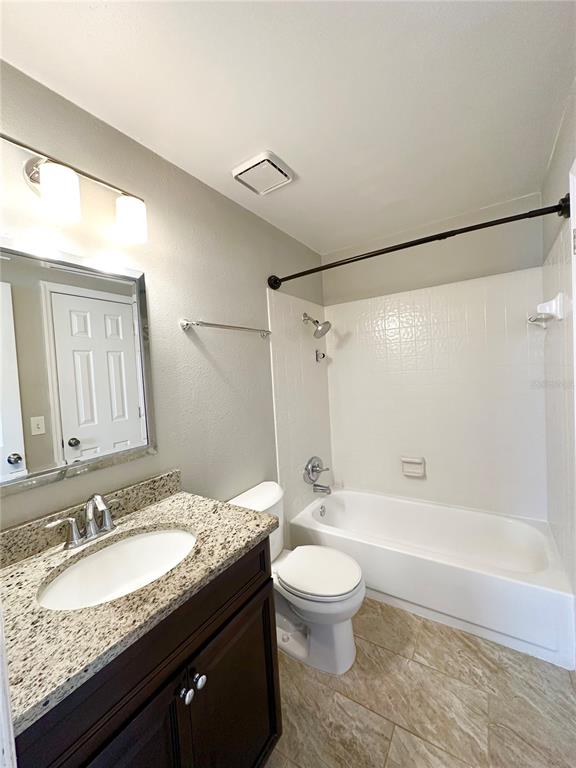 654 Roaring Drive, Unit 228 Altamonte Springs, FL 32714 - Photo 30 of 37 a bathroom with a granite countertop sink toilet and shower