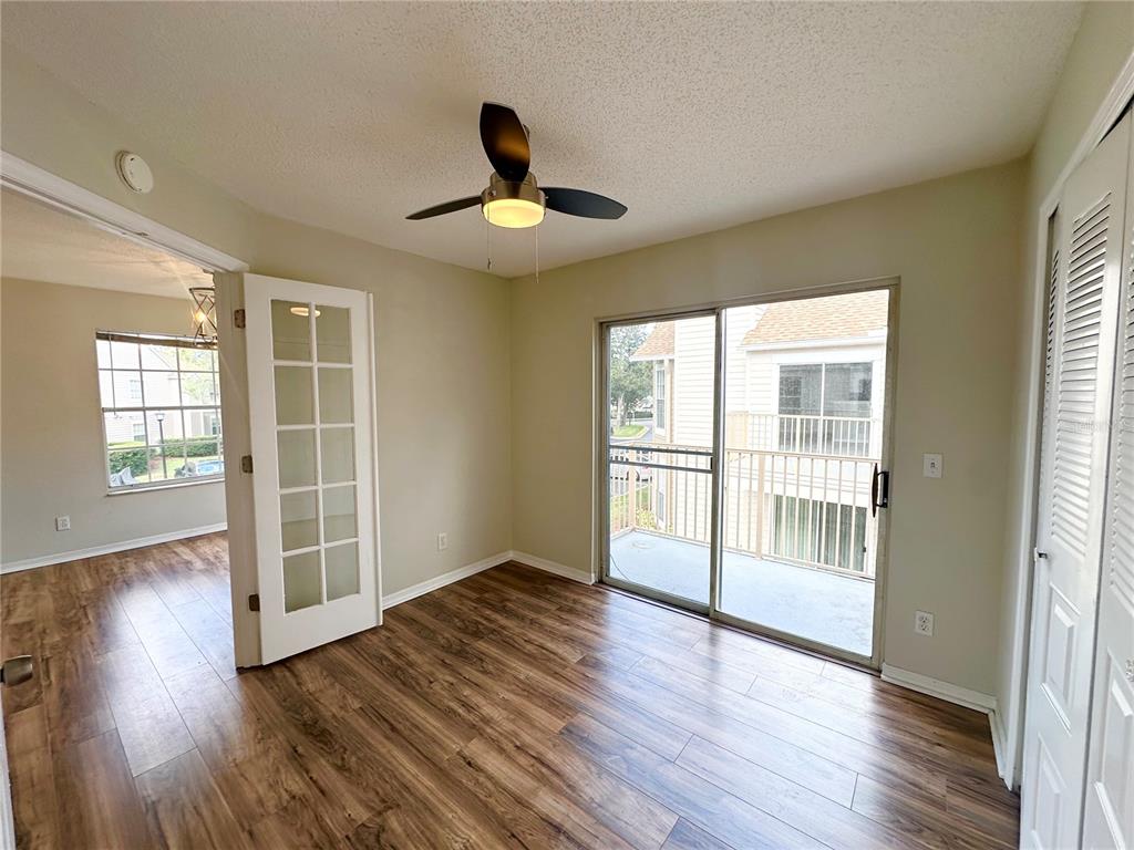654 Roaring Drive, Unit 228 Altamonte Springs, FL 32714 - Photo 31 of 37 a view of an empty room with wooden floor and a window