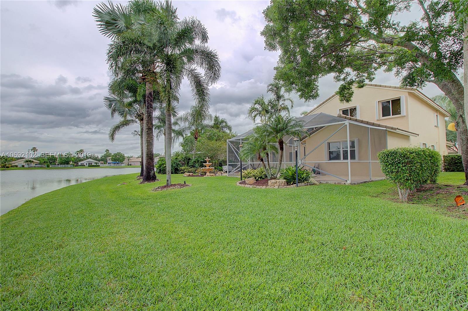 4113 Sapphire Bend Weston, FL 33331 - Photo 1 of 30 a front view of a house with garden