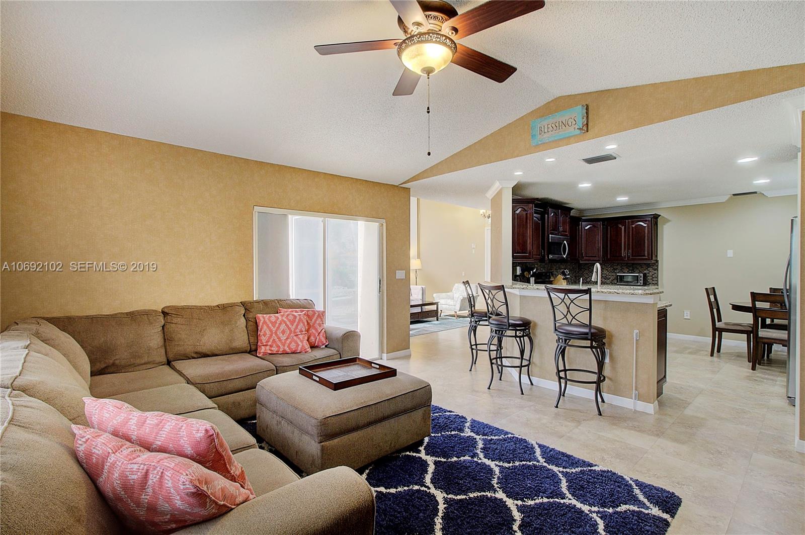 4113 Sapphire Bend Weston, FL 33331 - Photo 13 of 30 a living room with furniture a ceiling fan and a rug