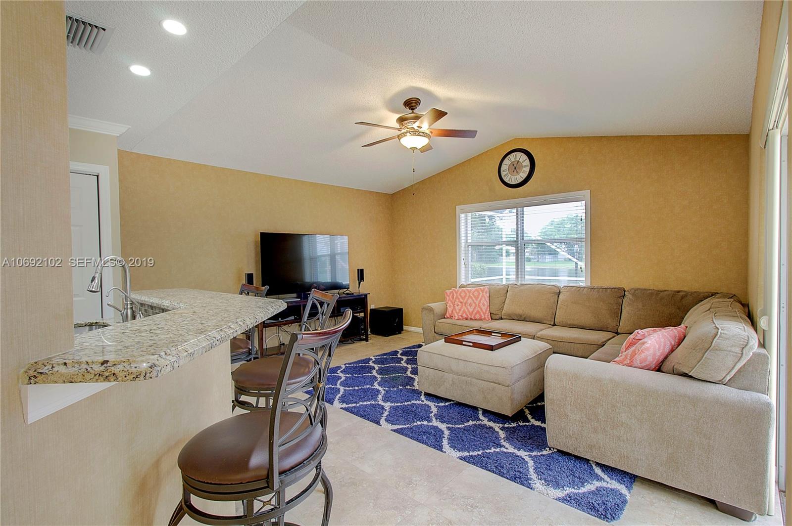 4113 Sapphire Bend Weston, FL 33331 - Photo 14 of 30 a living room with furniture and a flat screen tv