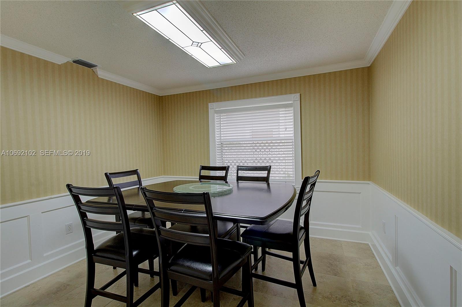 4113 Sapphire Bend Weston, FL 33331 - Photo 18 of 30 a view of a dining room with furniture and window