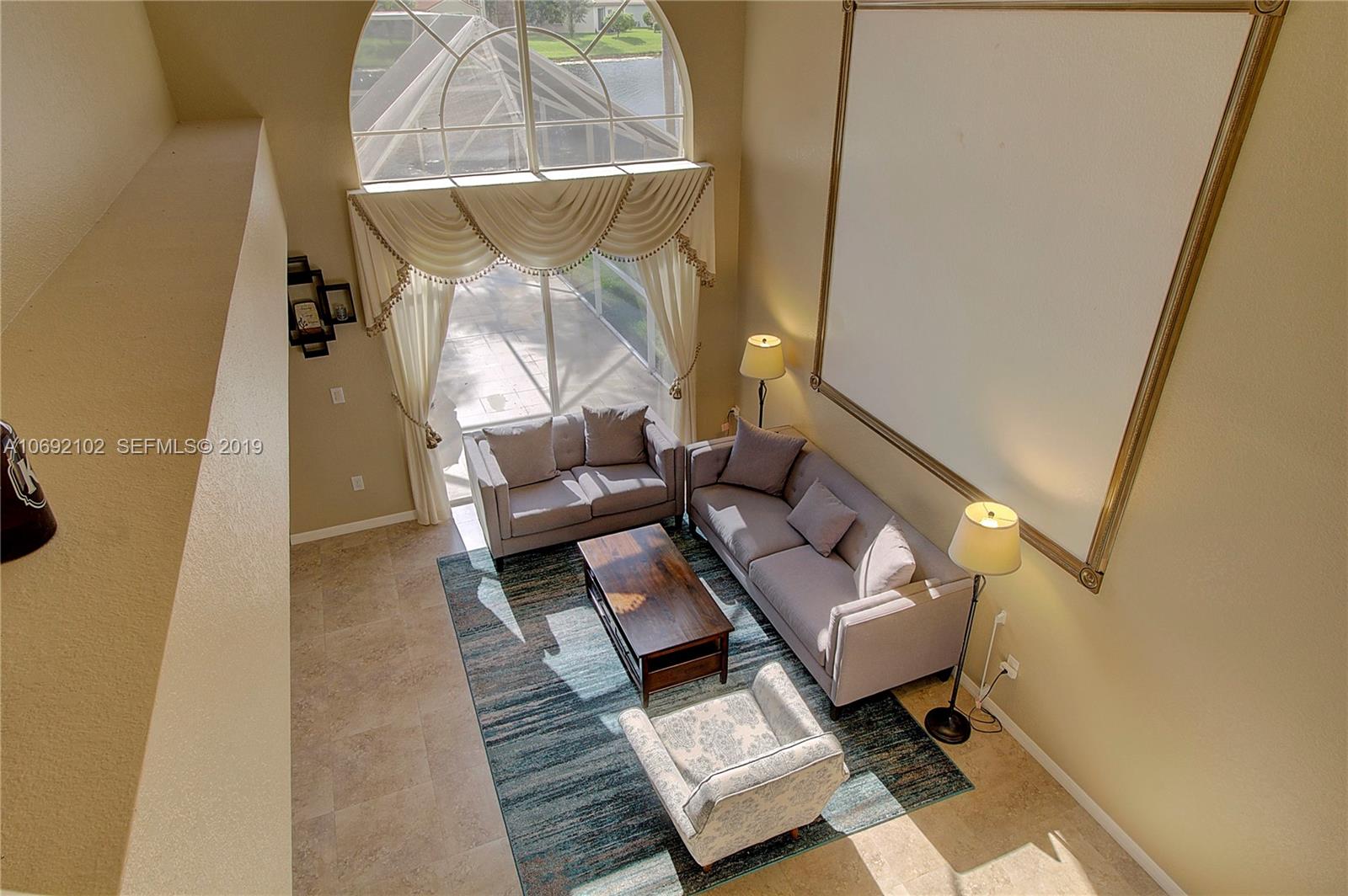 4113 Sapphire Bend Weston, FL 33331 - Photo 19 of 30 a living room with furniture and a window