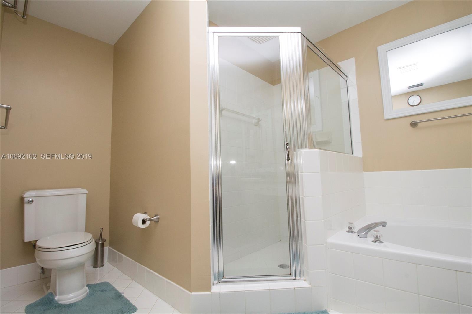 4113 Sapphire Bend Weston, FL 33331 - Photo 22 of 30 a bathroom with a toilet a sink and bathtub