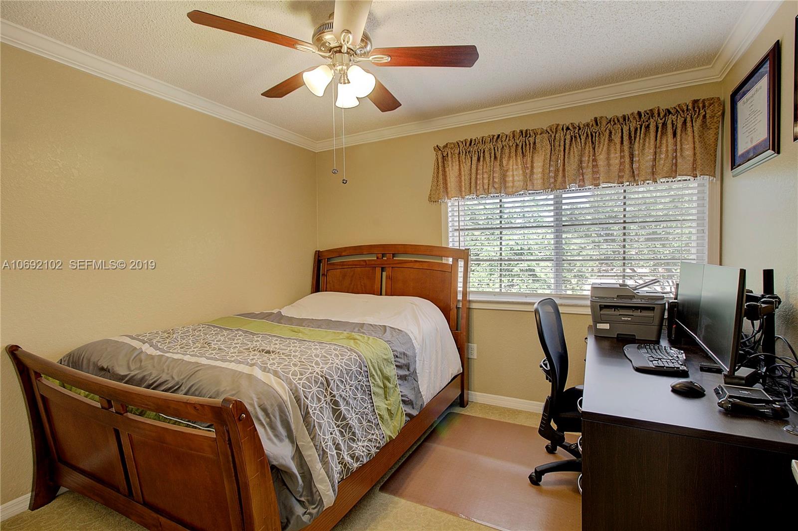 4113 Sapphire Bend Weston, FL 33331 - Photo 23 of 30 a bedroom with a bed and a desk