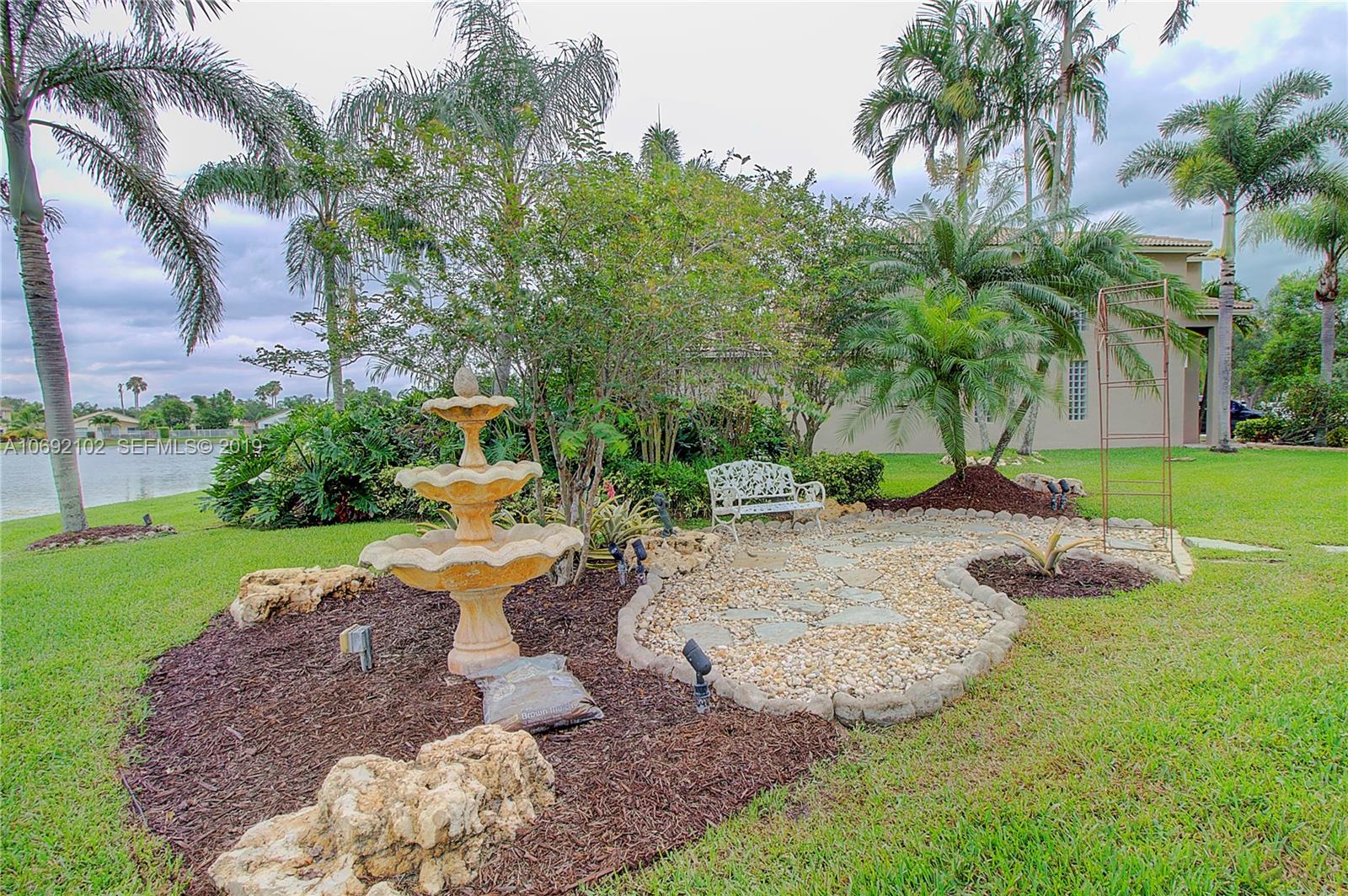 4113 Sapphire Bend Weston, FL 33331 - Photo 29 of 30 a view of a backyard with palm trees
