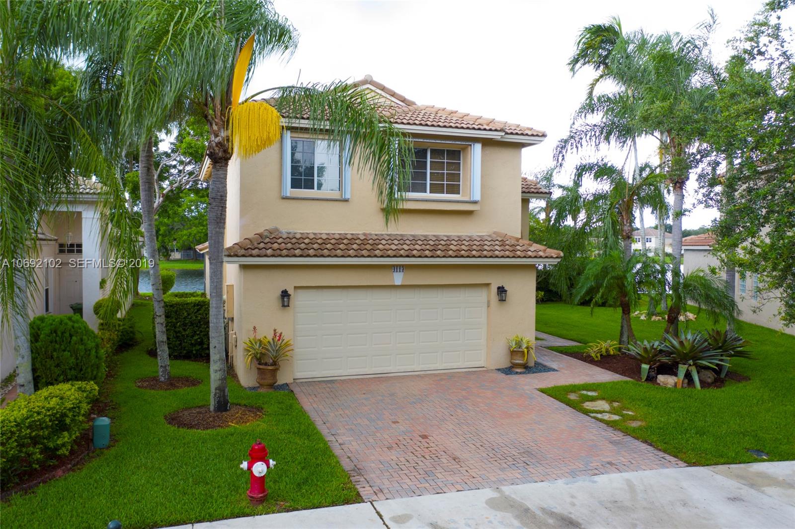 4113 Sapphire Bend Weston, FL 33331 - Photo 30 of 30 a front view of house with yard and green space