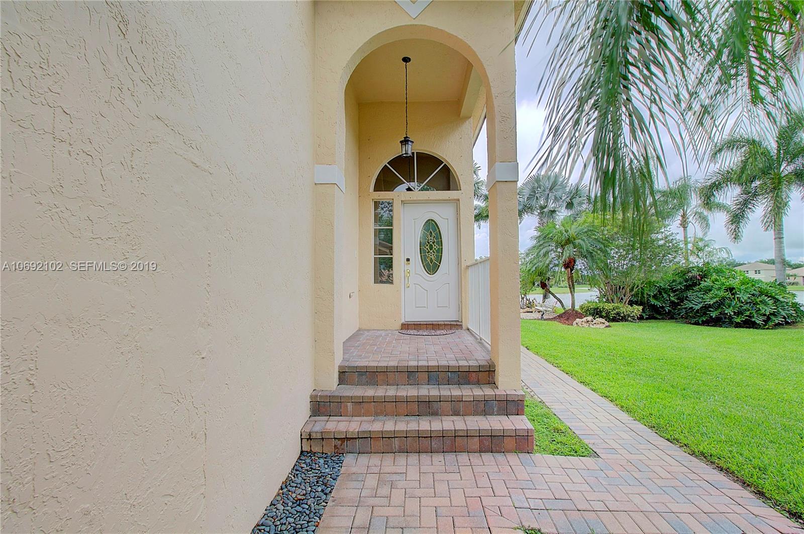 4113 Sapphire Bend Weston, FL 33331 - Photo 6 of 30 a front view of a house with garden
