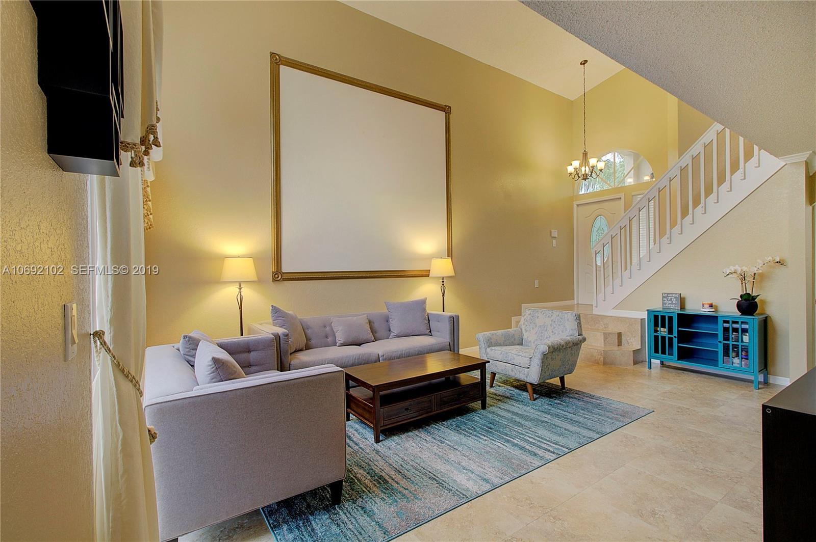 4113 Sapphire Bend Weston, FL 33331 - Photo 7 of 30 a living room with couches and a potted plant on coffee table