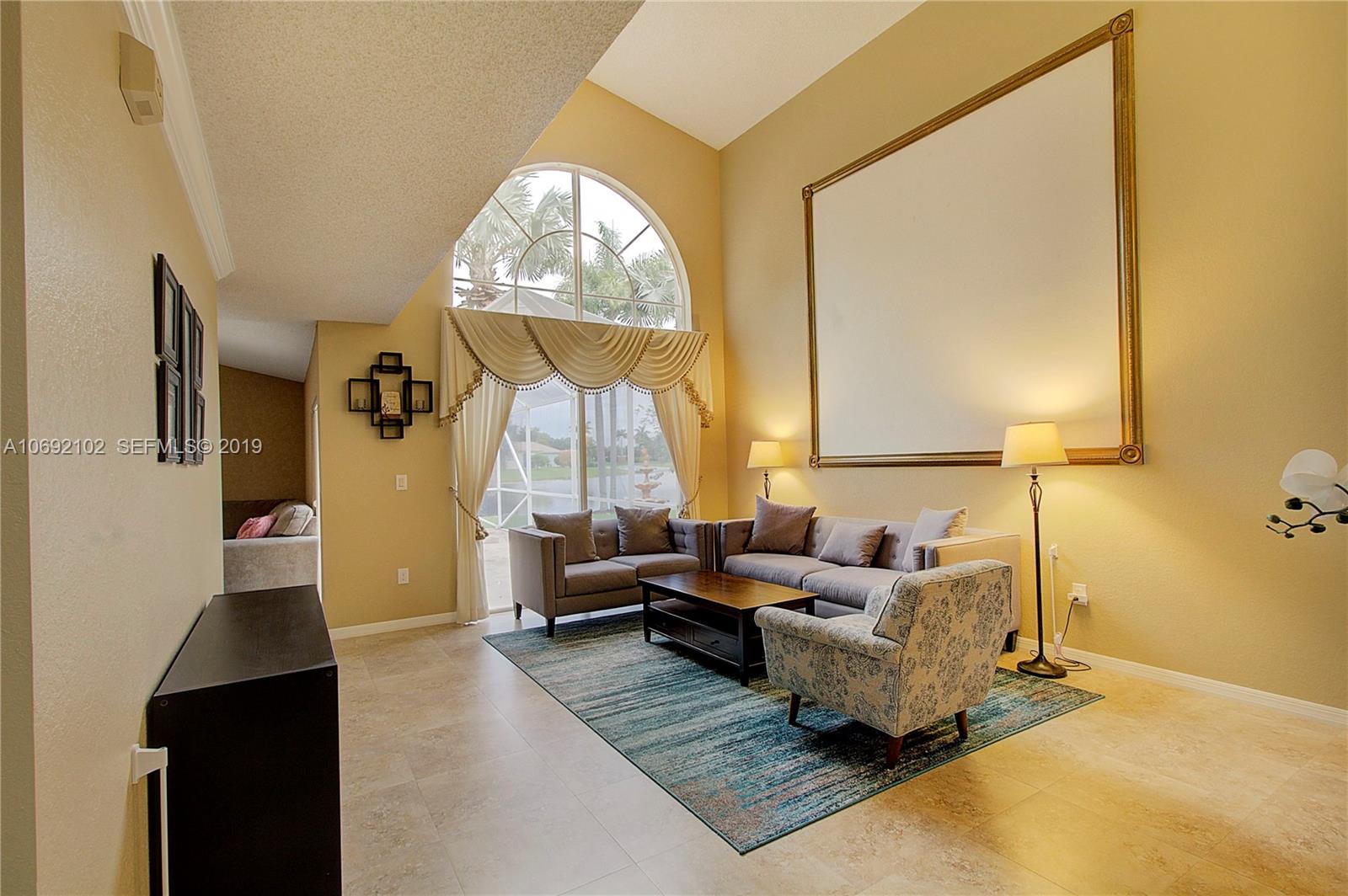 4113 Sapphire Bend Weston, FL 33331 - Photo 8 of 30 a living room with furniture and a large window