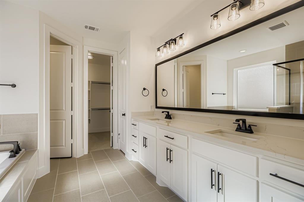 2300 Berman Street Celina, TX 75009 - Photo 15 of 29 a bathroom with a sink and a mirror
