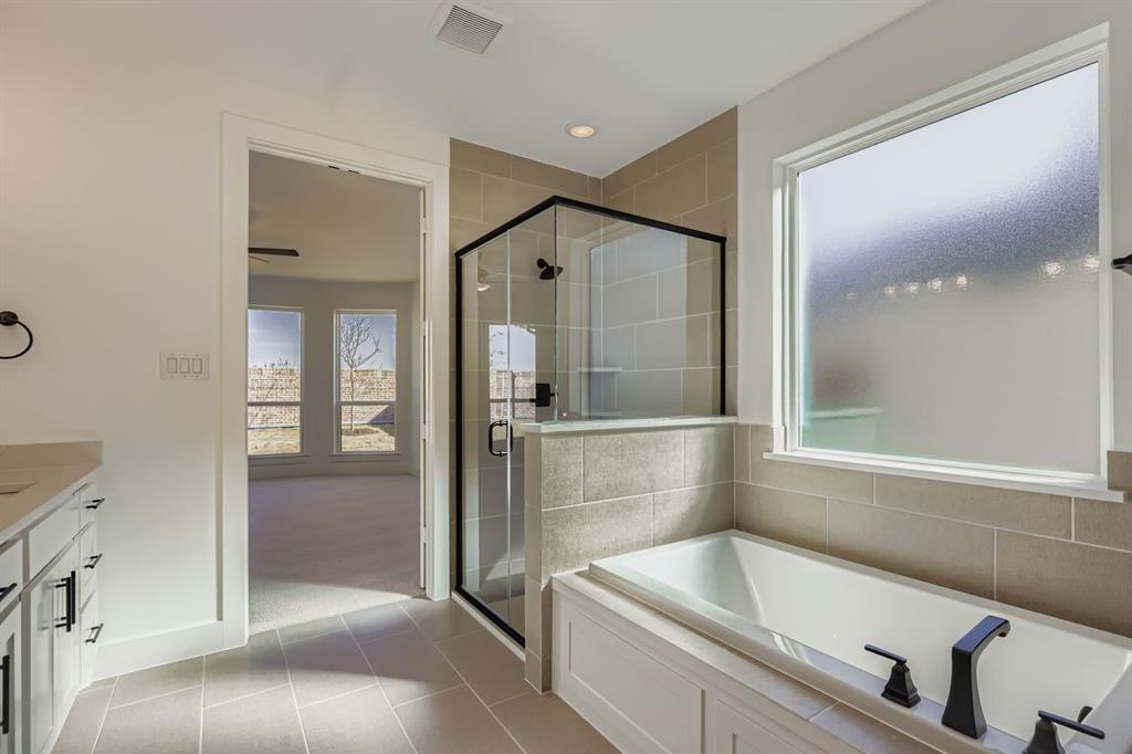 2300 Berman Street Celina, TX 75009 - Photo 16 of 29 a bathroom with a tub and shower