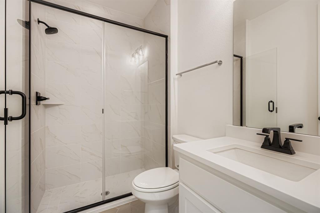2300 Berman Street Celina, TX 75009 - Photo 18 of 29 a bathroom with a sink a toilet and a shower