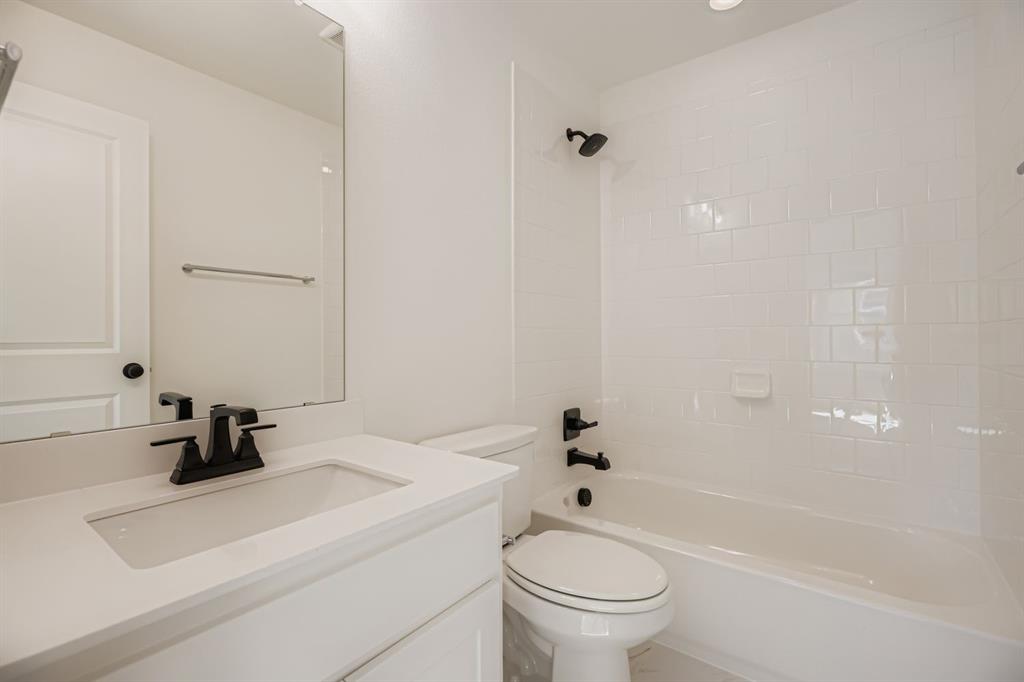 2300 Berman Street Celina, TX 75009 - Photo 20 of 29 a bathroom with a sink a toilet and shower