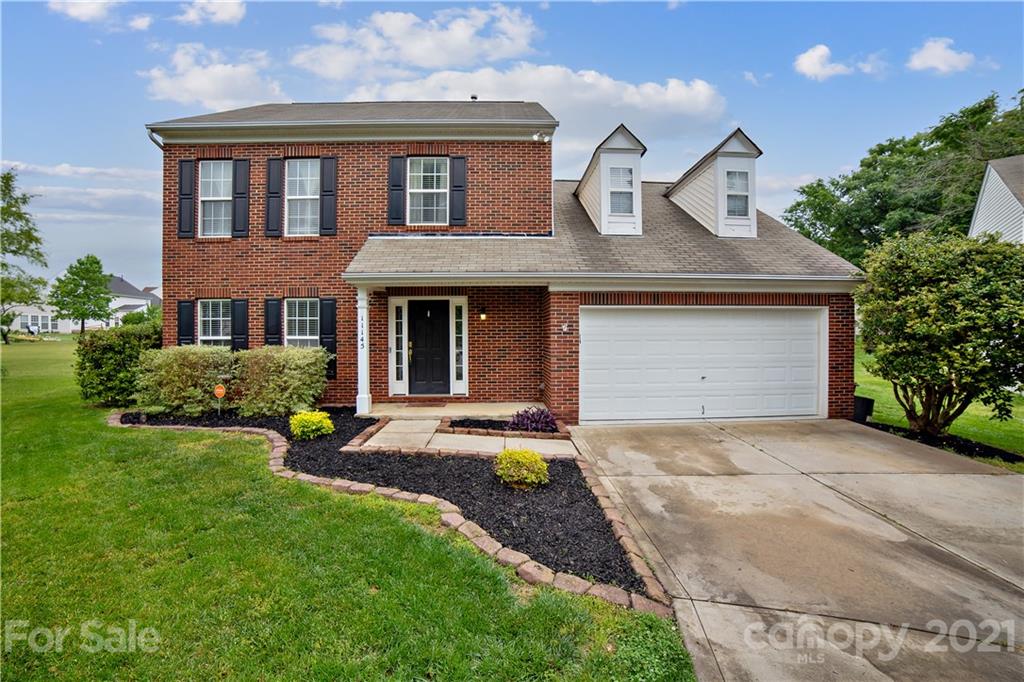 11145 Carver Pond Road Charlotte, NC 28269 - Photo 1 of 30 a front view of a house with a garden and plants