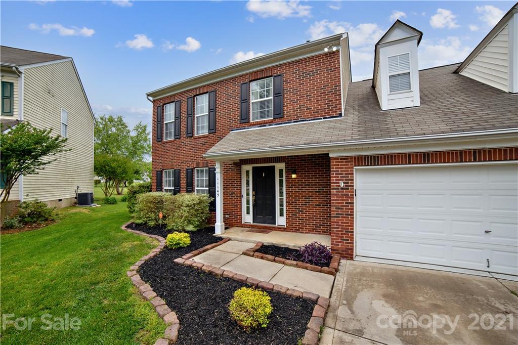 11145 Carver Pond Road Charlotte, NC 28269 - Photo 2 of 30 a front view of a house with garden
