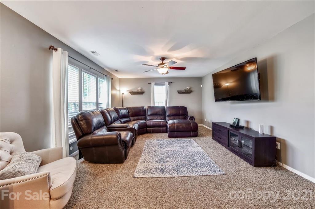11145 Carver Pond Road Charlotte, NC 28269 - Photo 11 of 30 a living room with furniture and a flat screen tv