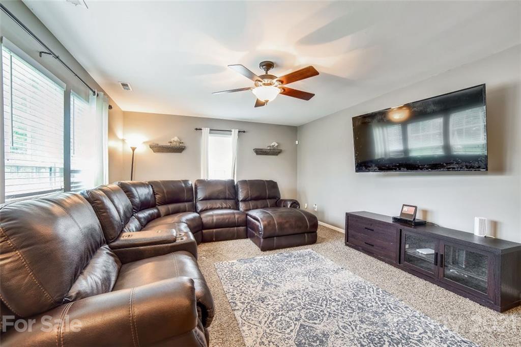 11145 Carver Pond Road Charlotte, NC 28269 - Photo 12 of 30 a living room with furniture and a flat screen tv