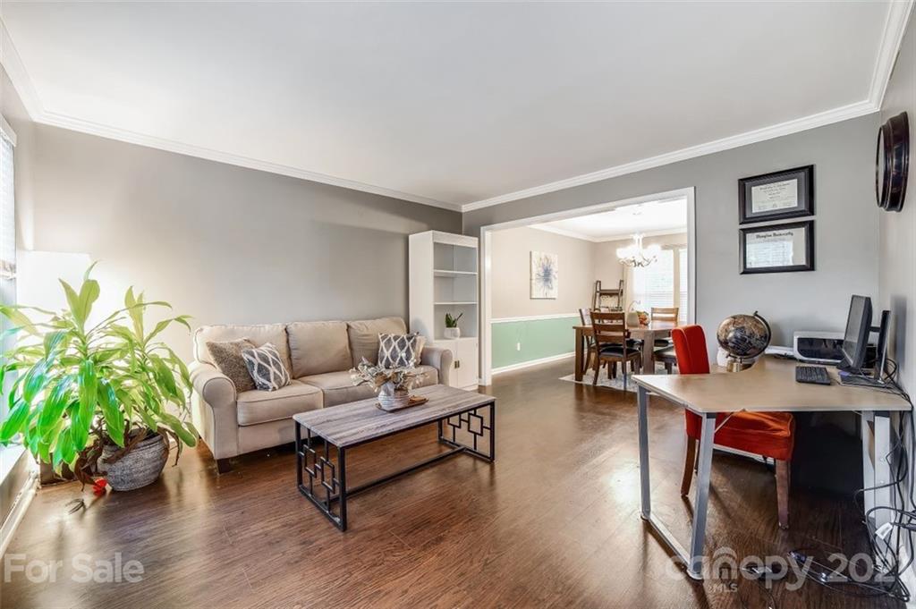 11145 Carver Pond Road Charlotte, NC 28269 - Photo 14 of 30 a living room with furniture and a wooden floor