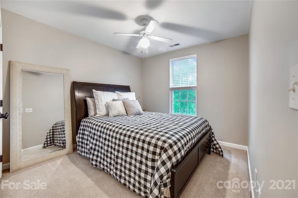 11145 Carver Pond Road Charlotte, NC 28269 - Photo 20 of 30 a bedroom with a bed and a window