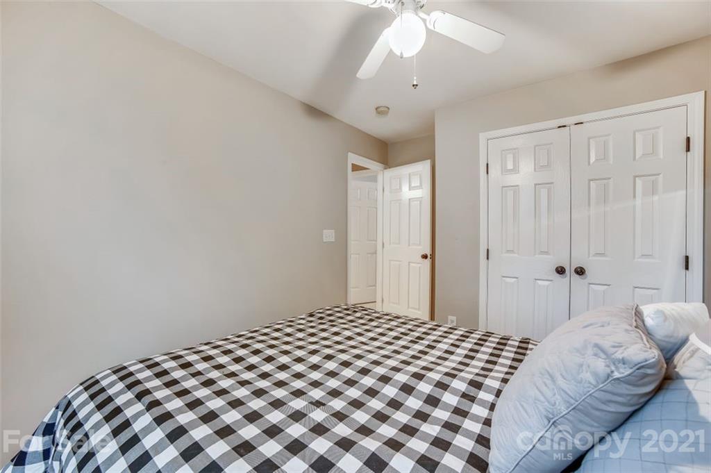 11145 Carver Pond Road Charlotte, NC 28269 - Photo 21 of 30 a bedroom with a bed and a lamp