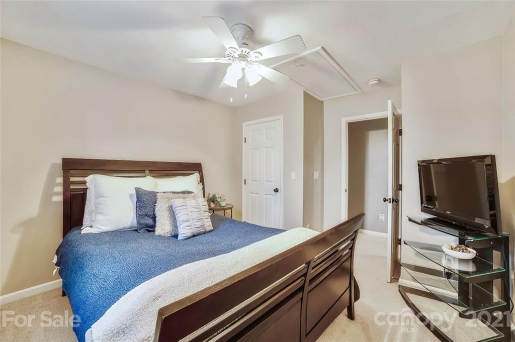 11145 Carver Pond Road Charlotte, NC 28269 - Photo 23 of 30 a bedroom with a bed and a flat screen tv