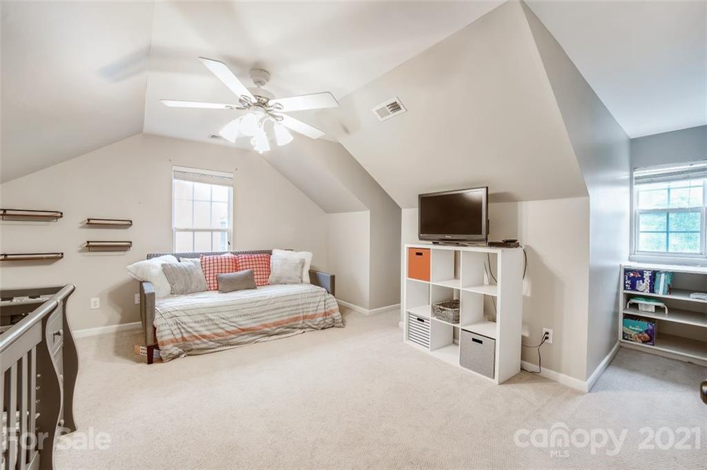 11145 Carver Pond Road Charlotte, NC 28269 - Photo 24 of 30 a living room with furniture and a flat screen tv