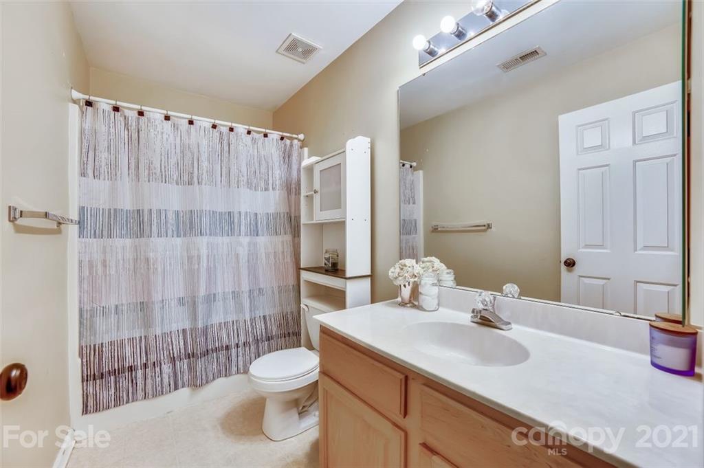 11145 Carver Pond Road Charlotte, NC 28269 - Photo 25 of 30 a bathroom with a sink toilet and shower