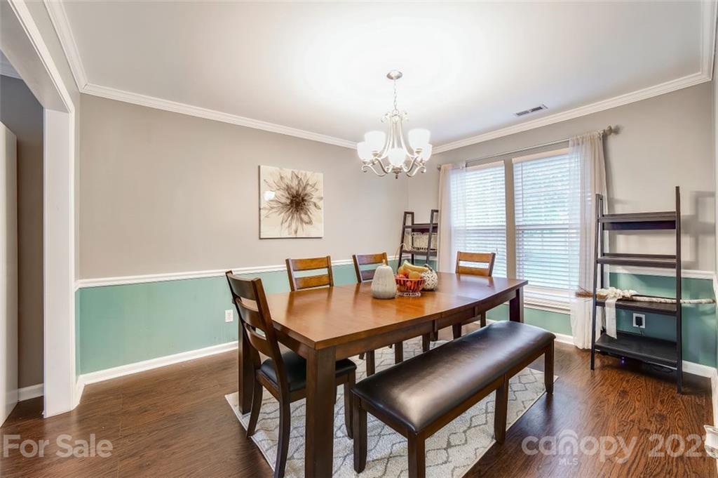 11145 Carver Pond Road Charlotte, NC 28269 - Photo 9 of 30 a view of a dining room with furniture window and wooden floor