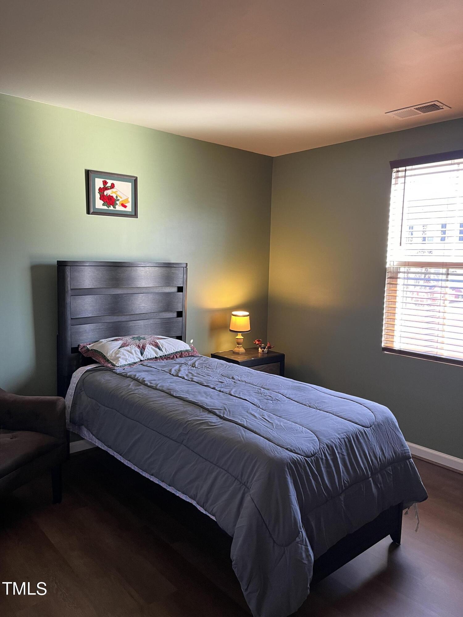 1408 Bridgewater Drive Durham, NC 27704 - Photo 13 of 41 a bedroom with a bed and cabinets