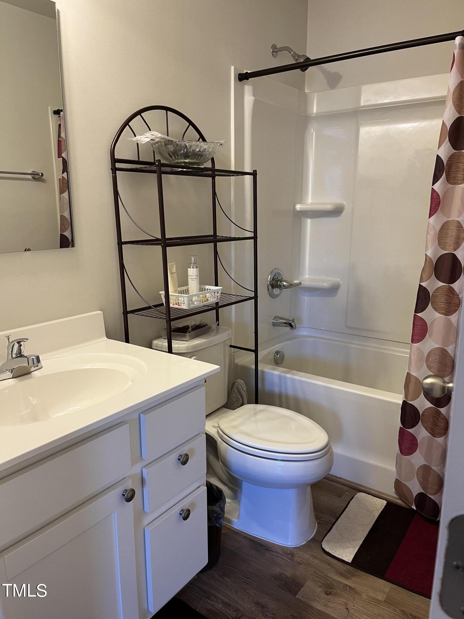 1408 Bridgewater Drive Durham, NC 27704 - Photo 16 of 41 a bathroom with a sink toilet and shower