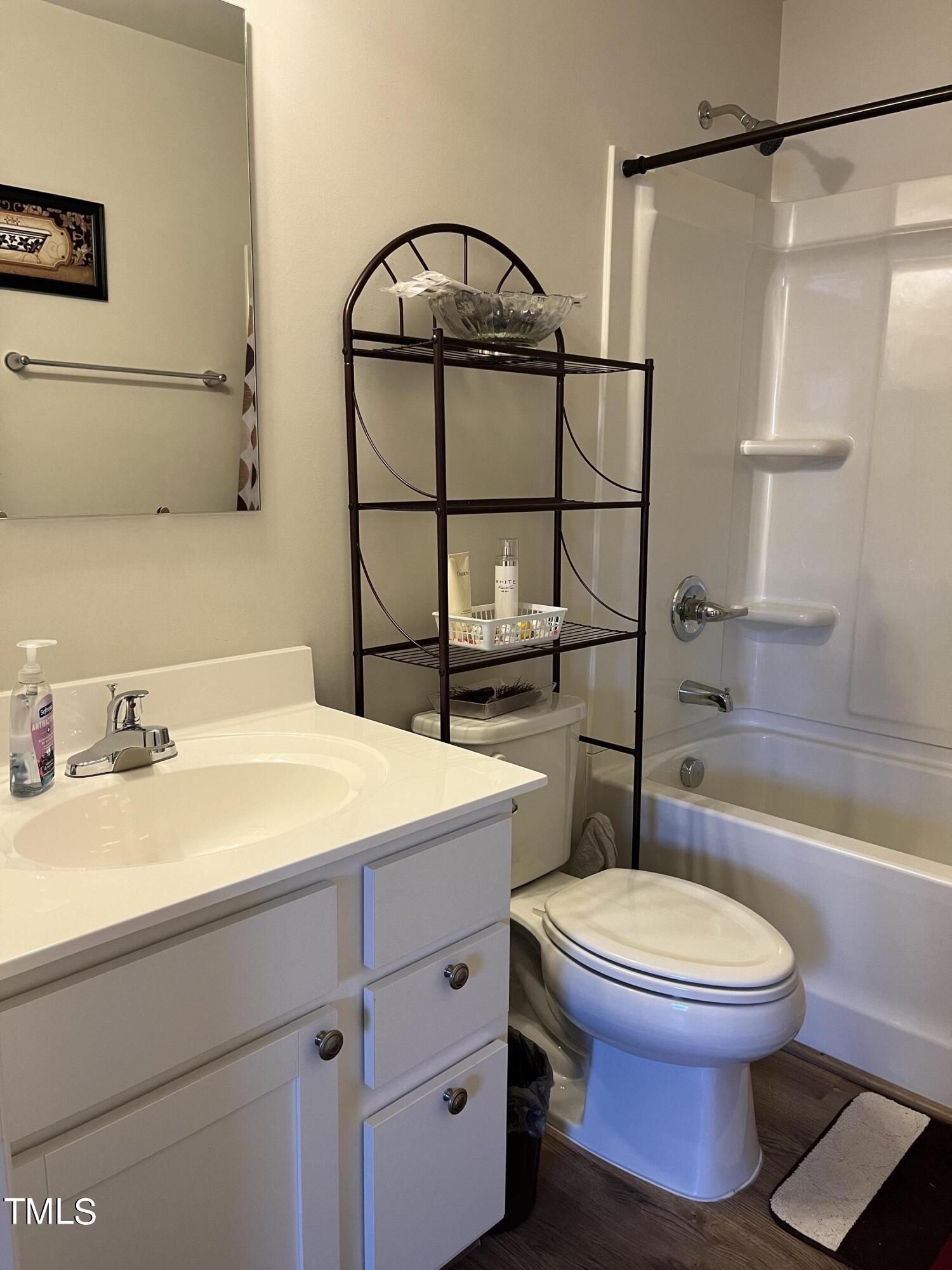 1408 Bridgewater Drive Durham, NC 27704 - Photo 17 of 41 a bathroom with a sink a toilet and a shower