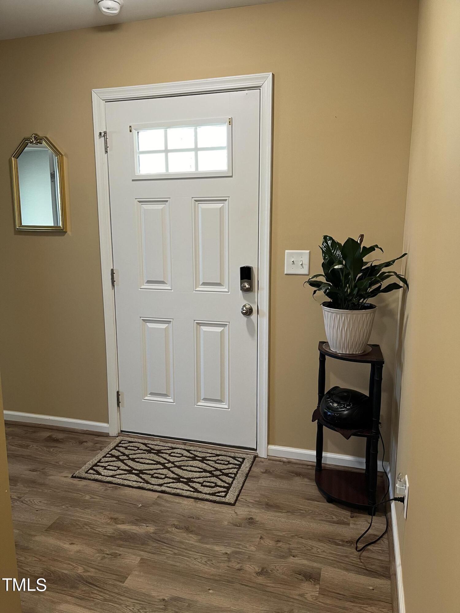 1408 Bridgewater Drive Durham, NC 27704 - Photo 18 of 41 a view of a livingroom with wooden floor and a potted plant