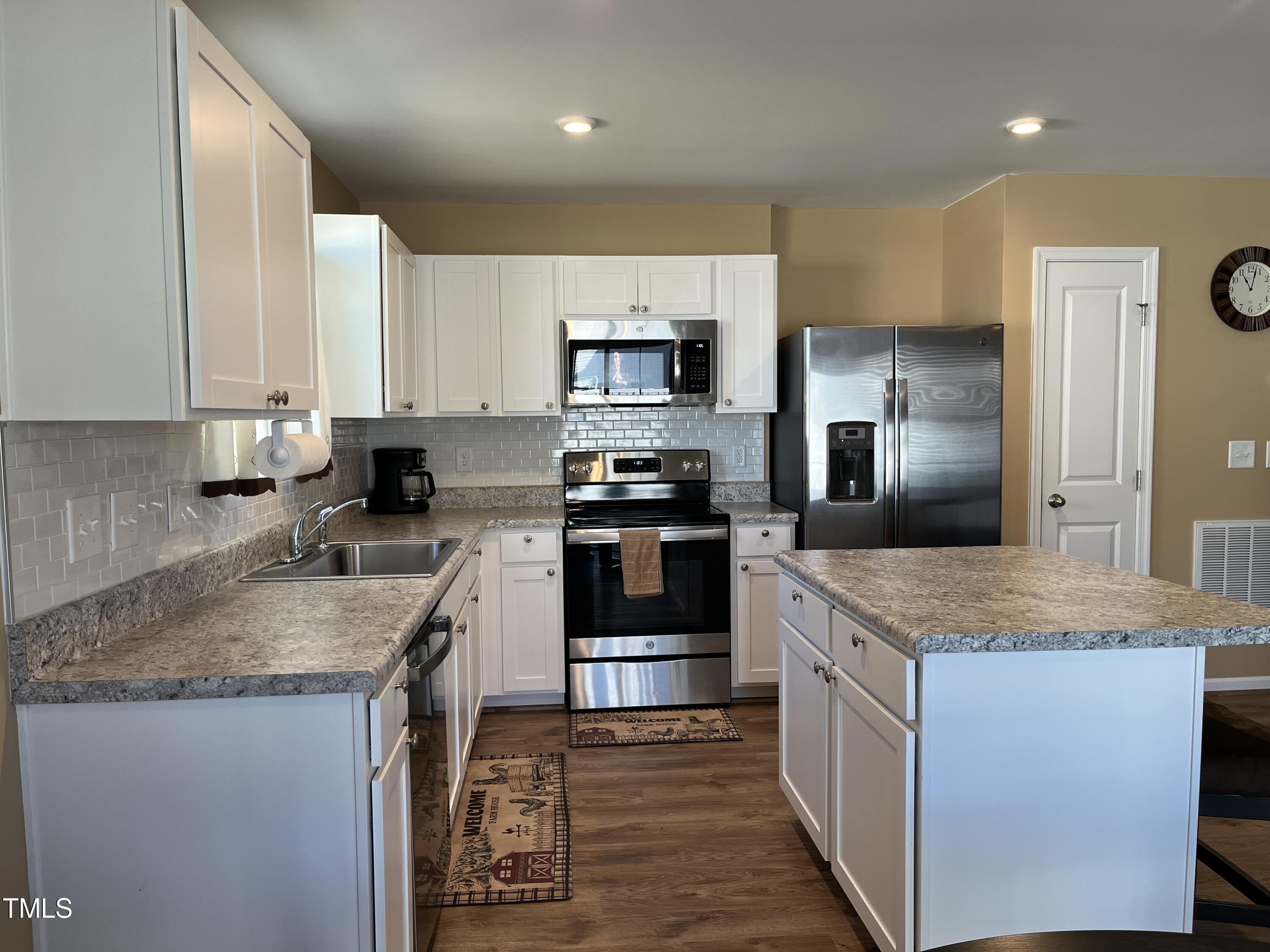 1408 Bridgewater Drive Durham, NC 27704 - Photo 31 of 41 a kitchen with stainless steel appliances granite countertop a sink stove and refrigerator