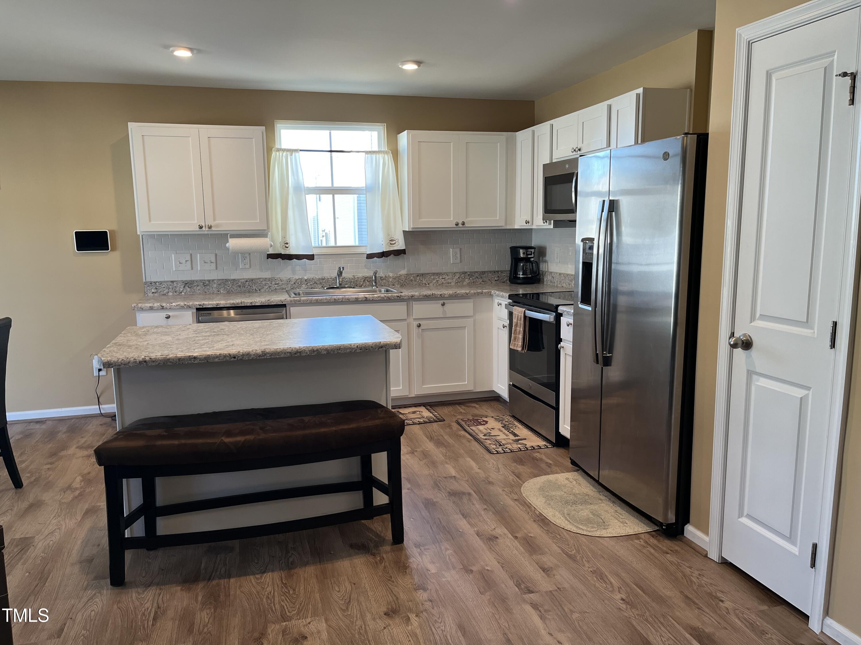 1408 Bridgewater Drive Durham, NC 27704 - Photo 33 of 41 a kitchen with a refrigerator sink and cabinets
