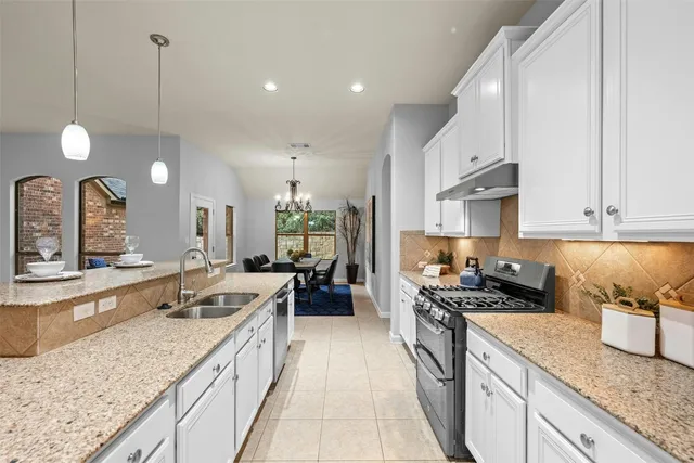 a kitchen with a table chairs refrigerator and microwave