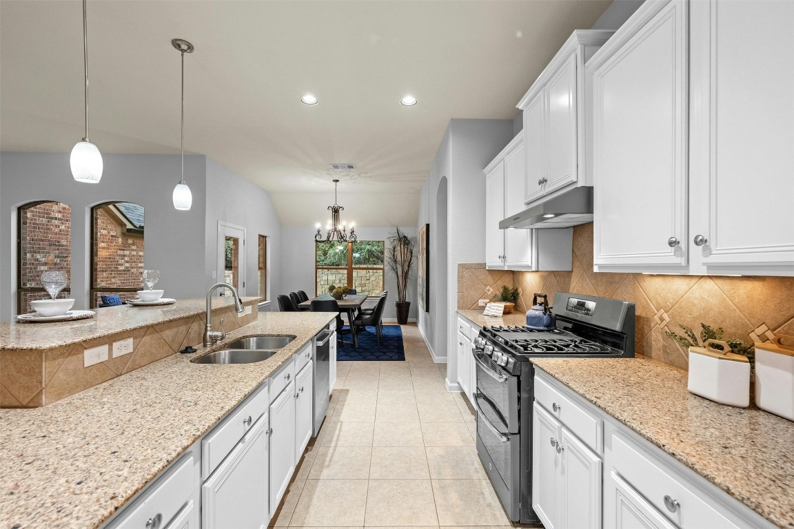 166 Briarpatch Court Austin, TX 78737 - Photo 10 of 40 a large kitchen with granite countertop lots of counter space and stainless steel appliances