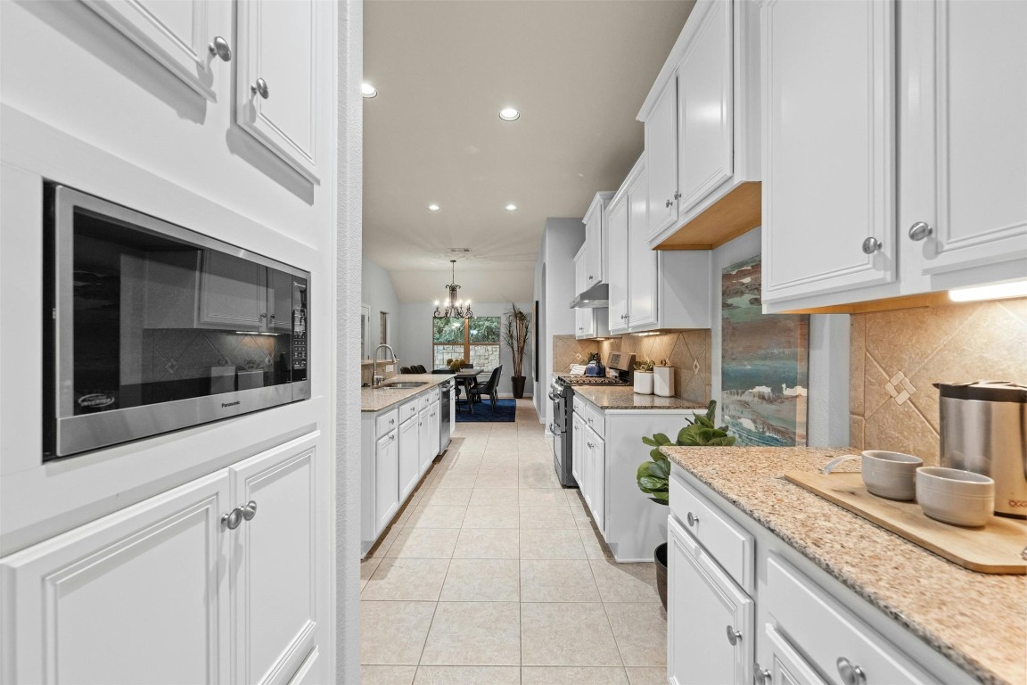 166 Briarpatch Court Austin, TX 78737 - Photo 11 of 40 a kitchen with a sink microwave and cabinets