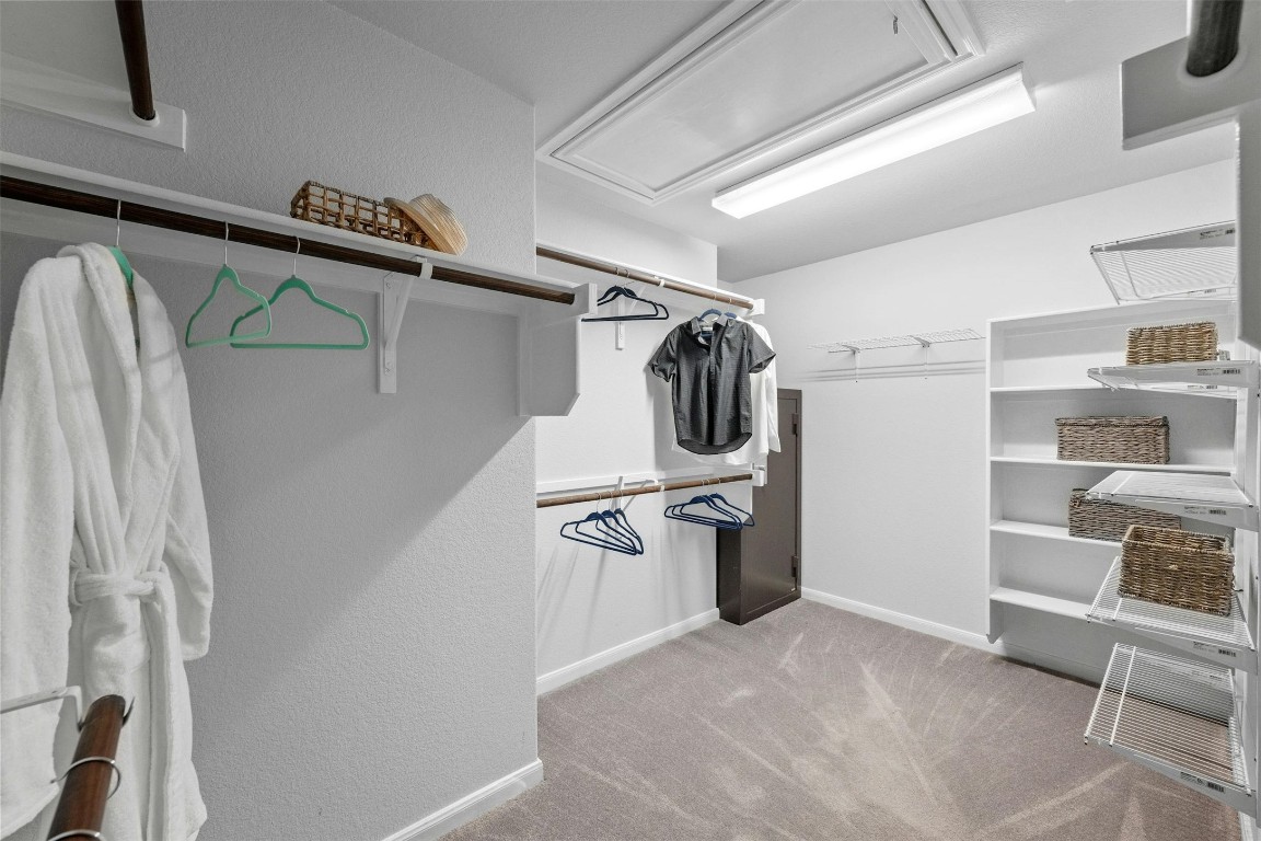 166 Briarpatch Court Austin, TX 78737 - Photo 18 of 40 a view of walk in closet with clothes and shoes