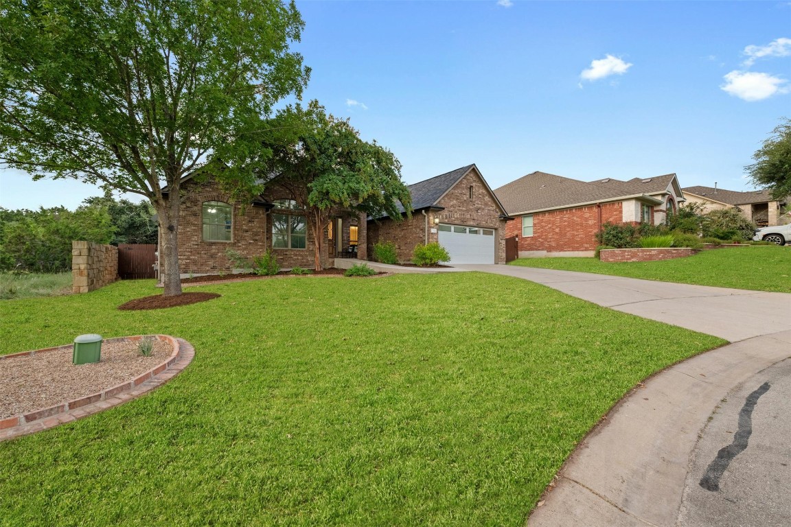 166 Briarpatch Court Austin, TX 78737 - Photo 2 of 40 a front view of house with yard and green space