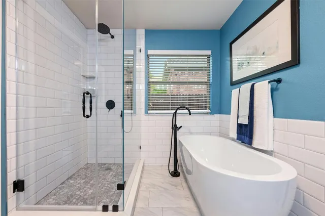 a spacious bathroom with a granite countertop sink a toilet a mirror and shower