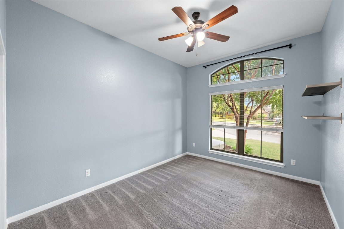 166 Briarpatch Court Austin, TX 78737 - Photo 23 of 40 an empty room with windows and ceiling fan