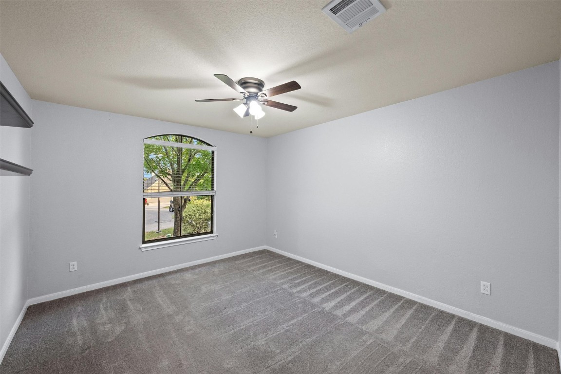 166 Briarpatch Court Austin, TX 78737 - Photo 25 of 40 an empty room with windows and ceiling fan