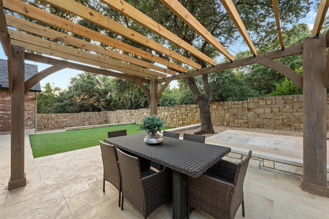 166 Briarpatch Court Austin, TX 78737 - Photo 31 of 40 a view of a patio with a table chairs and a backyard