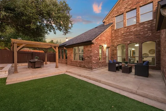 a view of a patio with a table chairs and a backyard